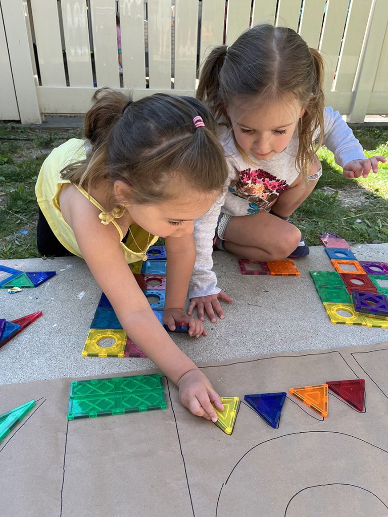 Two girls at the Saint Miriam School learning colors and shapes through play.